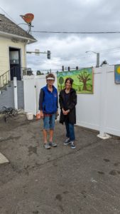 Carol Janowicz poses with director Argelia Grassfield in front of completed mural at Homeward House